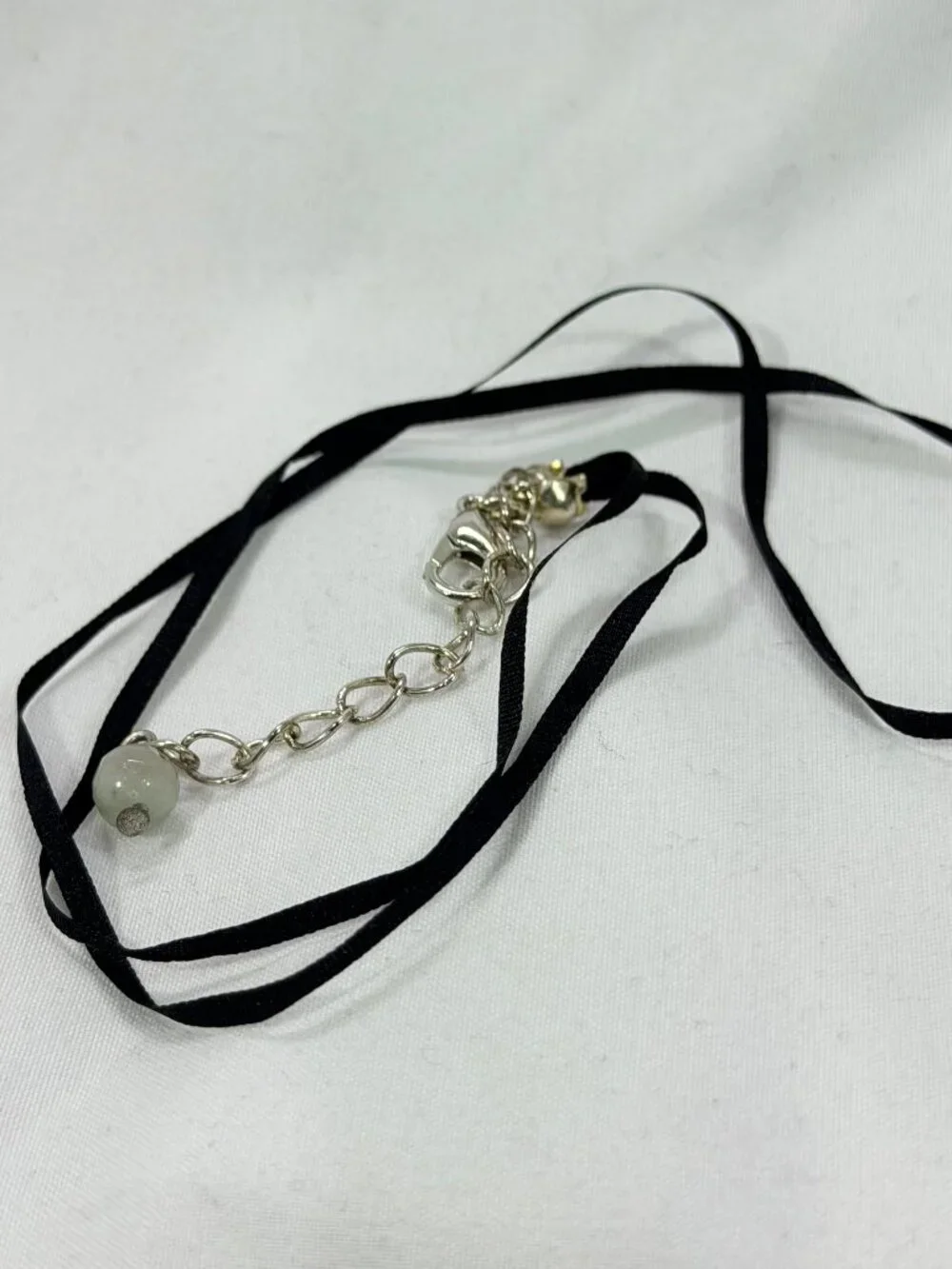 Elegant Silver and Black Necklace with an earthy colored bead